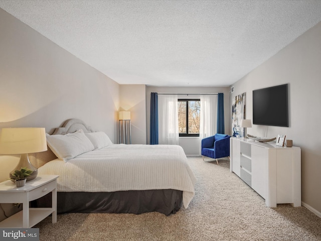 carpeted bedroom featuring a textured ceiling