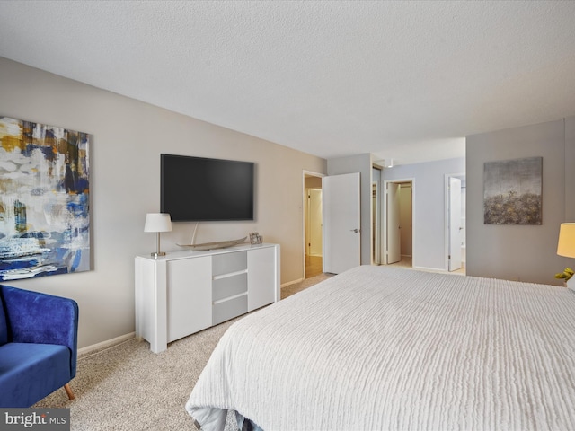 carpeted bedroom featuring a textured ceiling