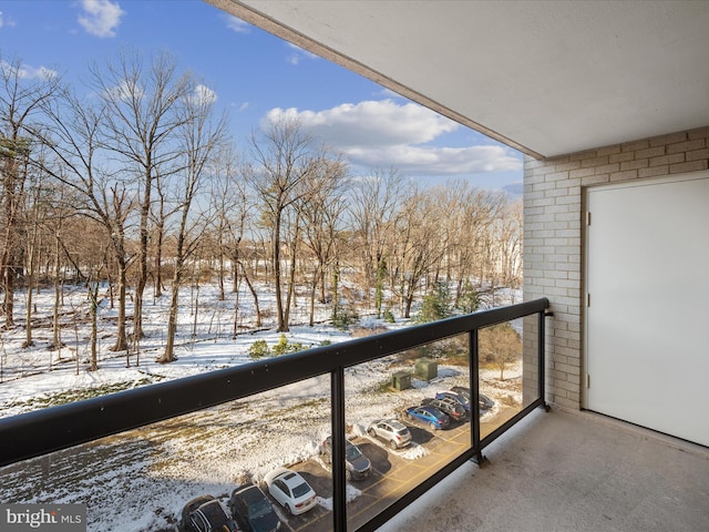 view of snow covered back of property