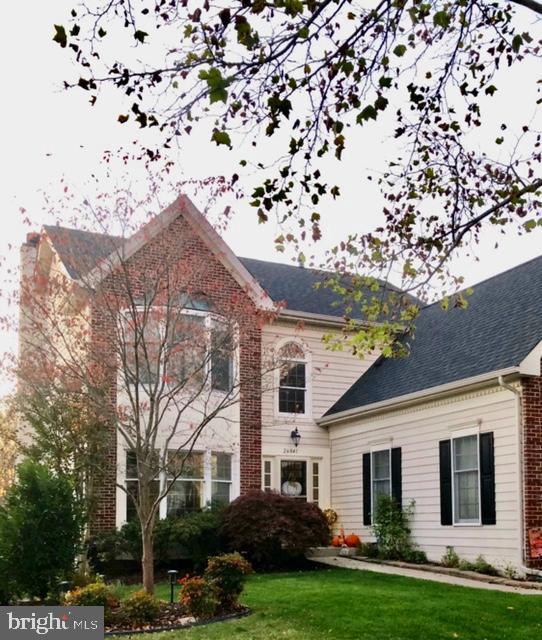 colonial-style house with a front yard