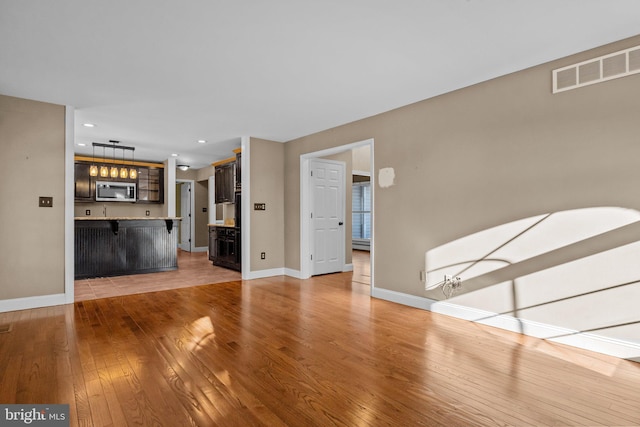 unfurnished living room featuring light hardwood / wood-style flooring