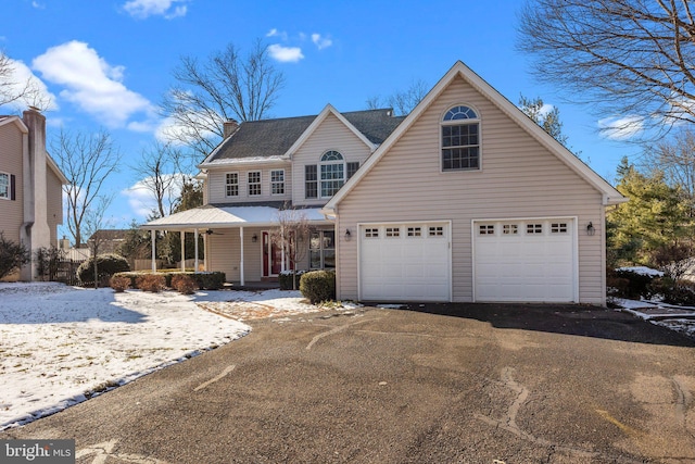 view of property featuring a porch and a garage