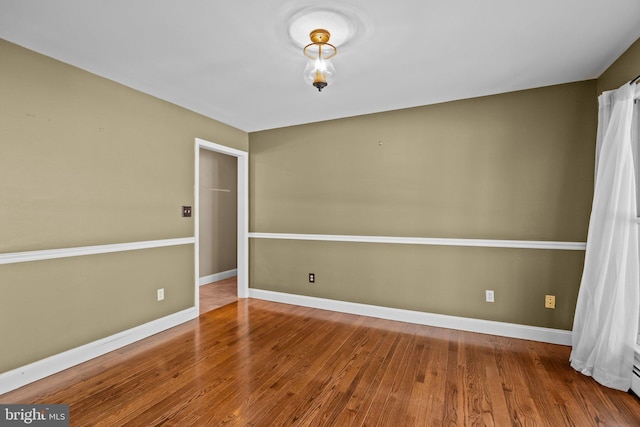 spare room with hardwood / wood-style floors