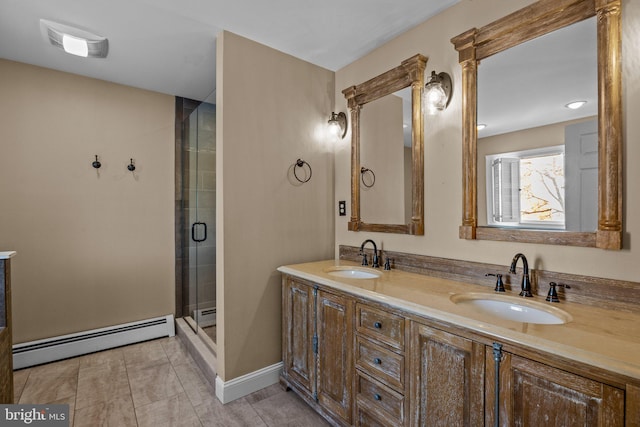 bathroom with a shower with door, vanity, and a baseboard heating unit