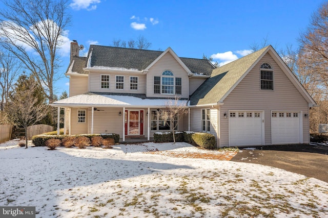 view of property with a porch and a garage