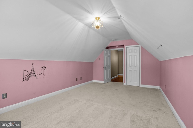 additional living space with light colored carpet and lofted ceiling