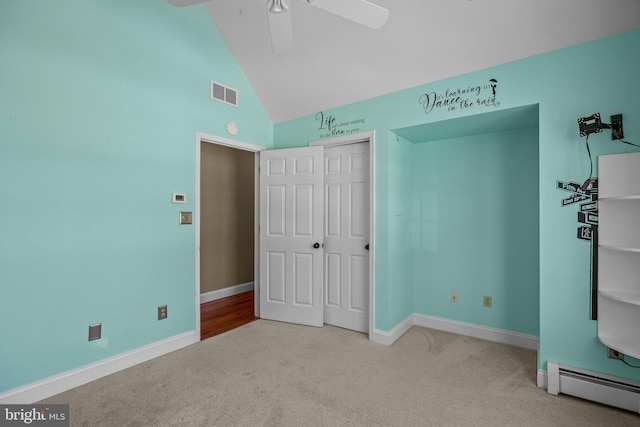 unfurnished bedroom with ceiling fan, a baseboard radiator, light colored carpet, lofted ceiling, and a closet