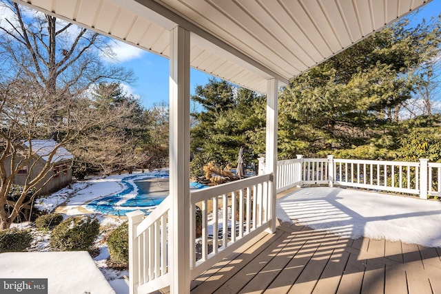 wooden terrace featuring a covered pool