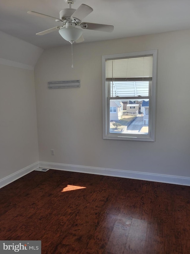 spare room with vaulted ceiling, ceiling fan, baseboards, and wood finished floors