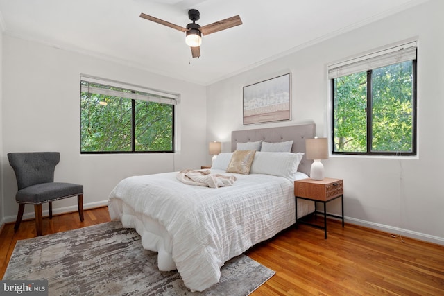 bedroom featuring ornamental molding, ceiling fan, and light hardwood / wood-style floors