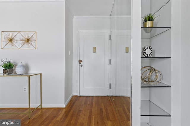 foyer featuring crown molding and dark hardwood / wood-style floors