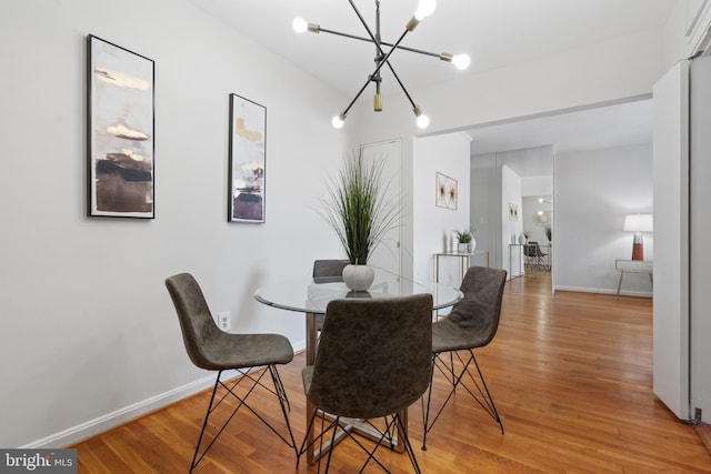 dining area with an inviting chandelier and wood-type flooring