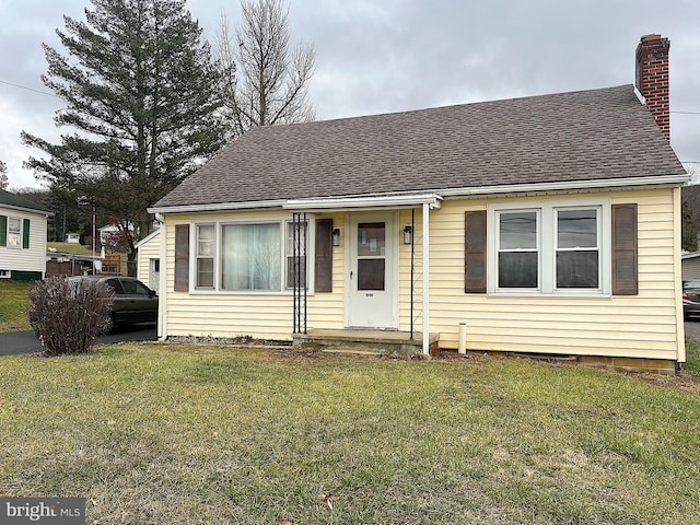 bungalow-style house with a front yard