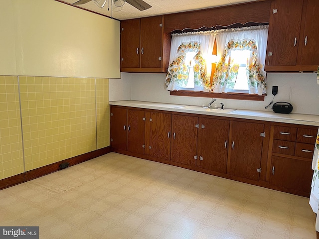 kitchen featuring ceiling fan and sink