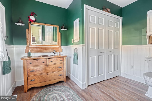 bathroom featuring hardwood / wood-style flooring, vanity, and toilet