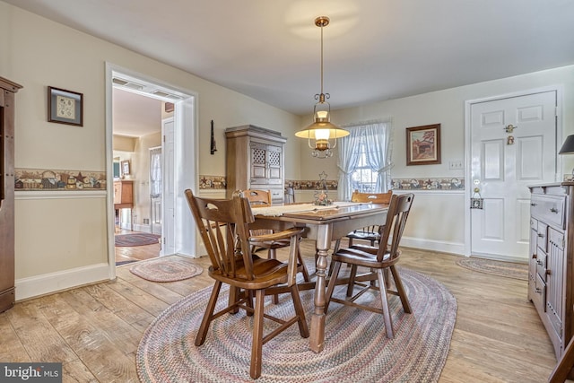 dining area with light hardwood / wood-style floors