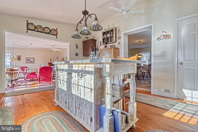 dining space featuring ceiling fan and wood-type flooring