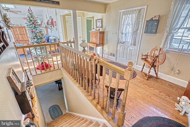 stairway featuring hardwood / wood-style floors and electric panel