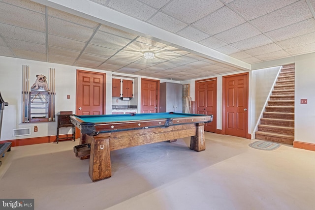 rec room featuring a paneled ceiling, pool table, and concrete floors