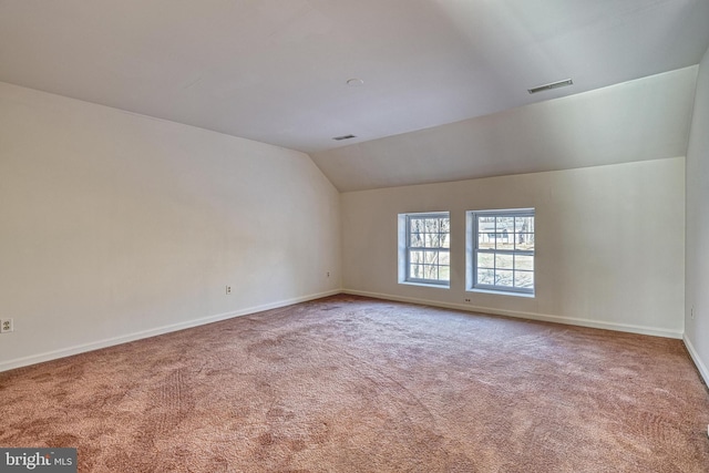 additional living space with carpet floors and lofted ceiling