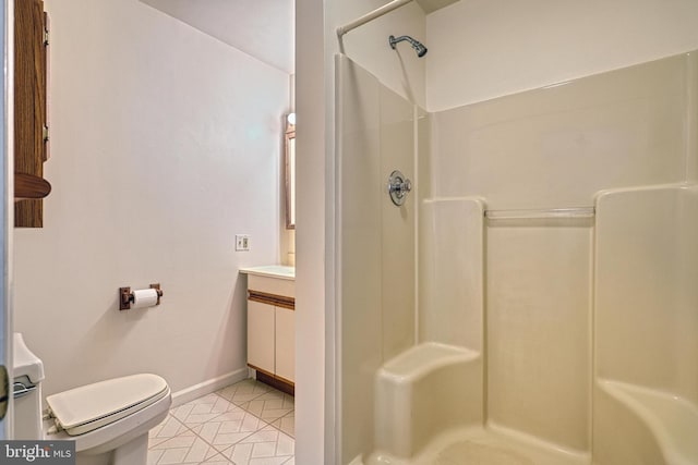 bathroom featuring toilet, tile patterned flooring, and walk in shower