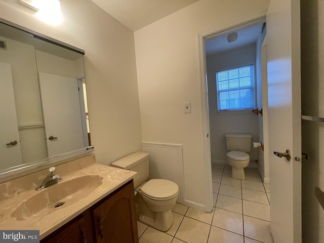 bathroom with tile patterned floors, vanity, and toilet