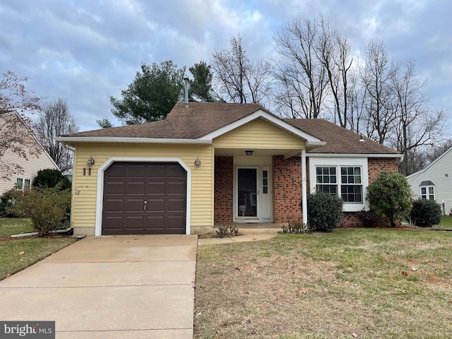 single story home featuring a front lawn and a garage