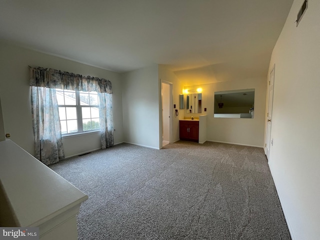 carpeted spare room with sink