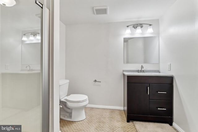 bathroom with tile patterned floors, a shower, vanity, and toilet