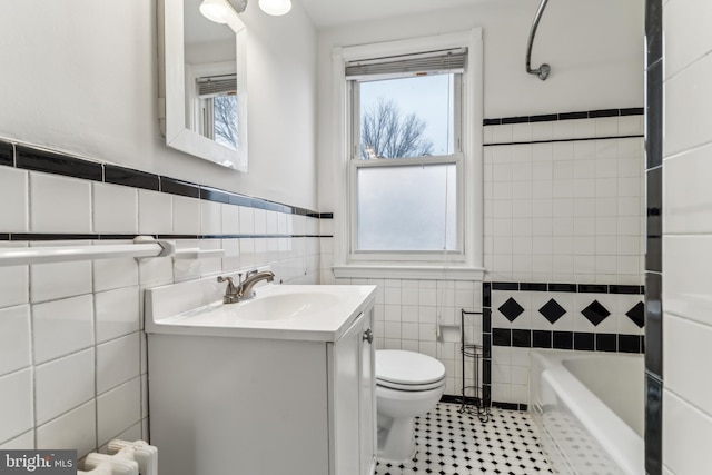 full bathroom with tile patterned flooring, toilet, vanity, independent shower and bath, and tile walls