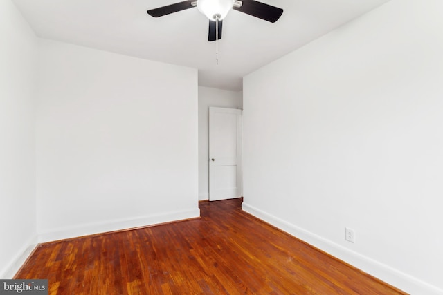 spare room with dark hardwood / wood-style floors and ceiling fan