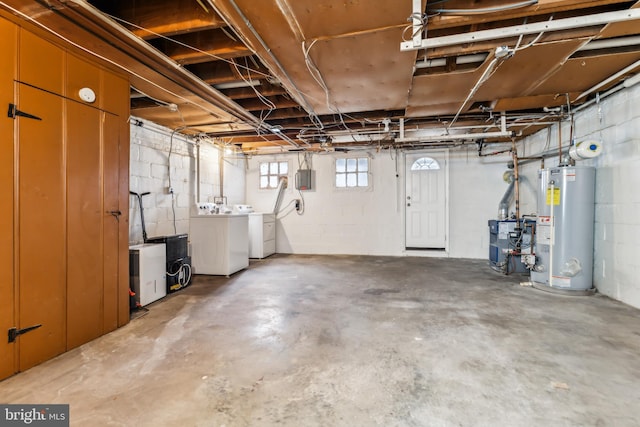 basement with water heater and independent washer and dryer