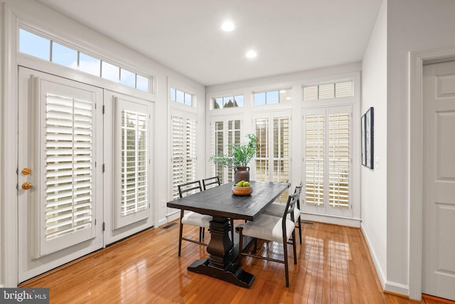 dining area featuring light hardwood / wood-style floors and a healthy amount of sunlight