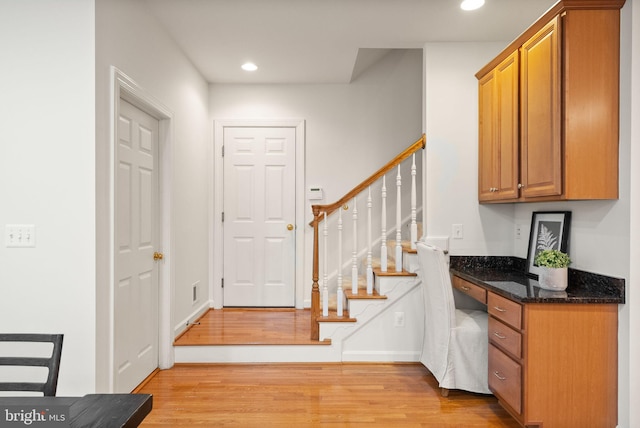 entryway featuring light hardwood / wood-style flooring and built in desk