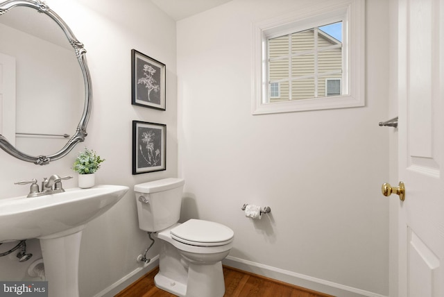 bathroom featuring sink, wood-type flooring, and toilet