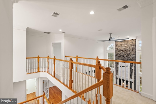 hallway featuring wood-type flooring and ornamental molding