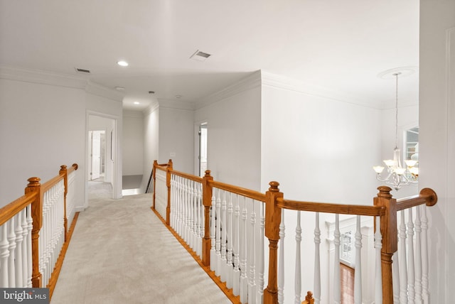 corridor with light carpet, a notable chandelier, and crown molding