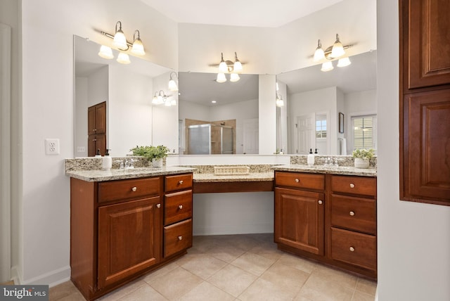 bathroom featuring tile patterned flooring, vanity, and walk in shower