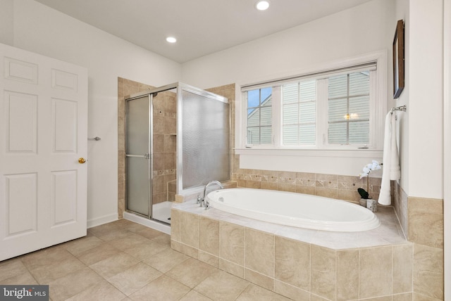 bathroom featuring tile patterned flooring and shower with separate bathtub