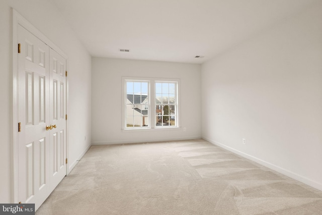 unfurnished bedroom featuring light carpet