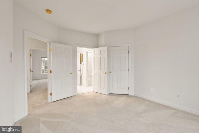 unfurnished bedroom with light carpet