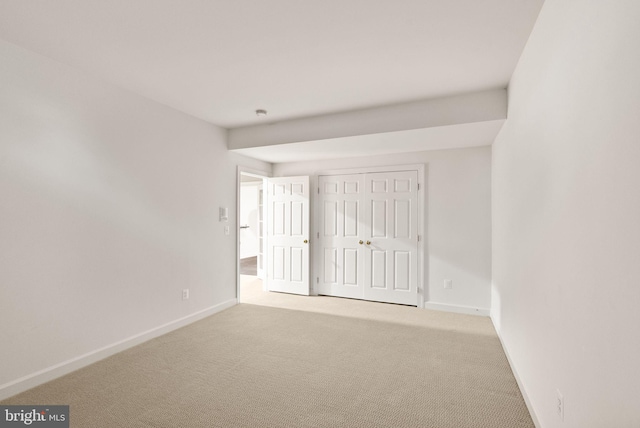 unfurnished room with light carpet