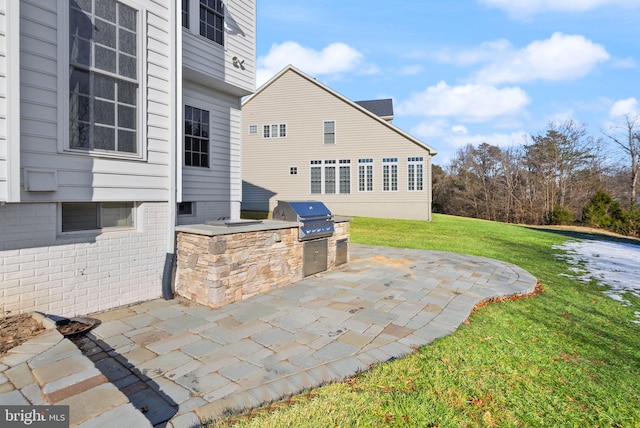 view of patio / terrace featuring a grill and exterior kitchen