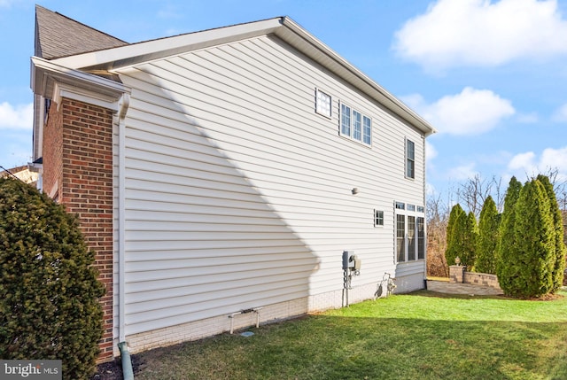 view of home's exterior featuring a yard