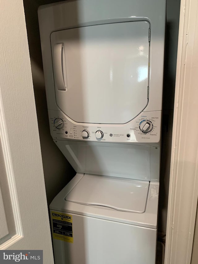 laundry room featuring stacked washer / drying machine