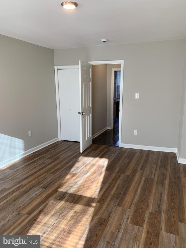 empty room featuring dark wood-type flooring