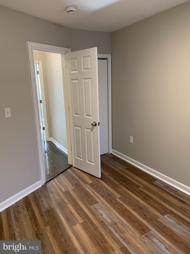 unfurnished bedroom featuring dark wood-type flooring