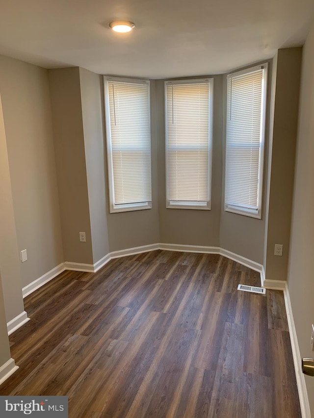 unfurnished room featuring dark hardwood / wood-style floors