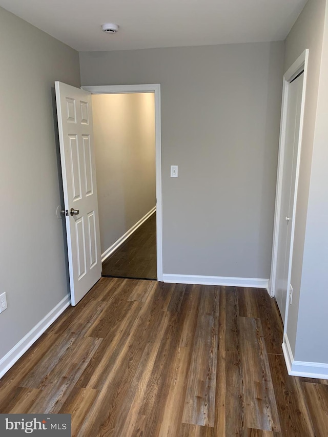 unfurnished bedroom featuring dark hardwood / wood-style floors