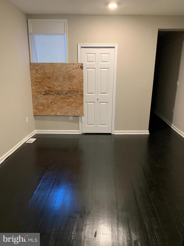 empty room featuring dark wood-type flooring